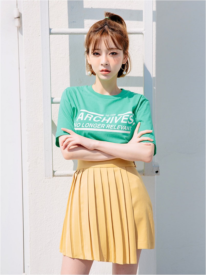 green t shirt with yellow skirt min